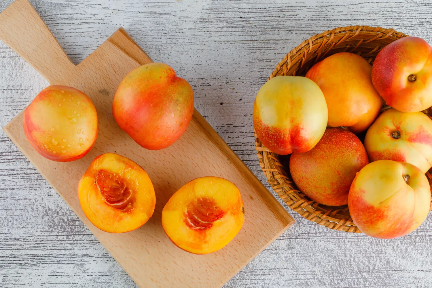 nectarines-basket-grungy-cutting-board-table-flat-lay